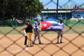 Team Playa players present the Cuban flag during the pre-game national anthem.