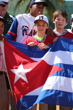 Holding the U.S. and Cuban flags, along with the Vermont state flag, side-by-side following the game against Playa.