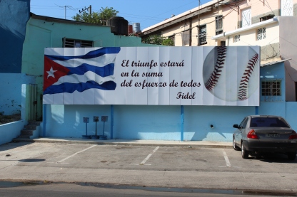 A billboard outside the Estadio Latinoamericano reading: "The triumph will be the sum of the efforts of all" when translated into English.