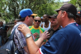 Vermont Coach Tom Simon chats with locals about baseball at the Hot Corner in Havana's Central Park.
