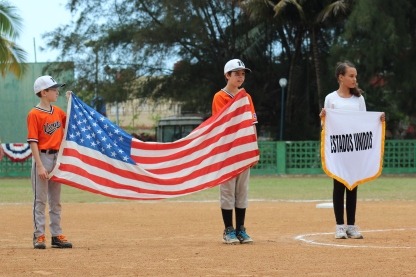 Vermont Player William Gumbrell holds the U.S. flag during the playing of the National Anthem.