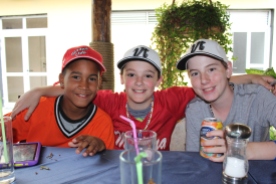 Ollie Pudvar (center) and Tate Agnew (far right) with a Cuban player during the post-game dinner.