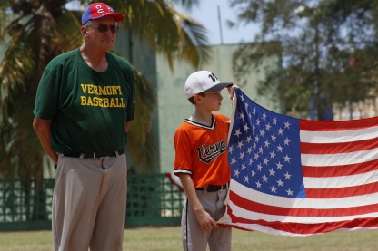 Vermont Coach Jim Carter alongside player August Rinehart during the playing of the National Anthem.